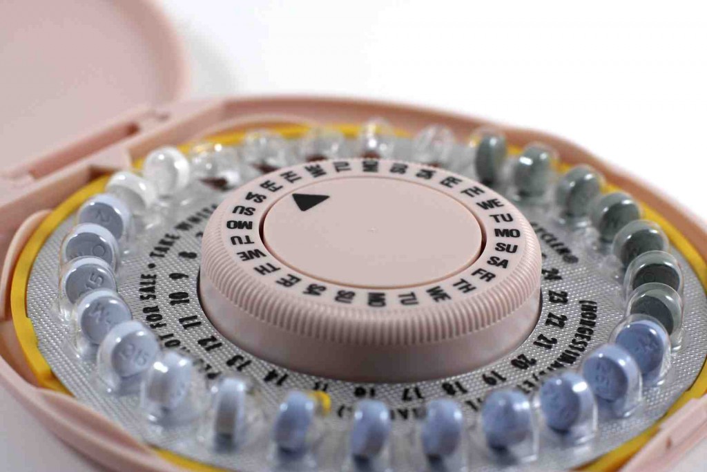 An open pack of birthcontrol pills on a white background with shallow depth of field